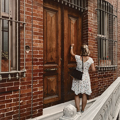 Woman knocking on door.