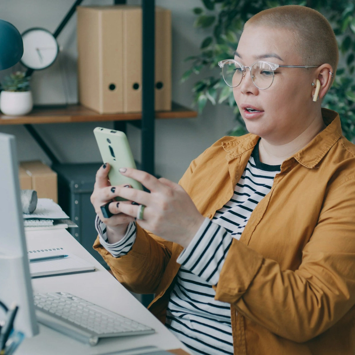 Woman working on phone at desk