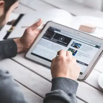 Man reading the news on a tablet.