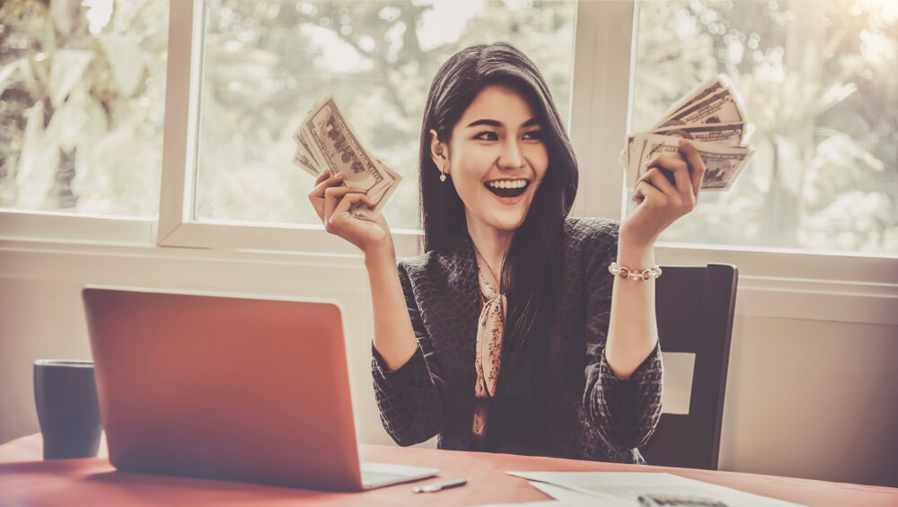 excited woman from getting online title loan cash in hand