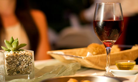 Glass of wine on a table with food