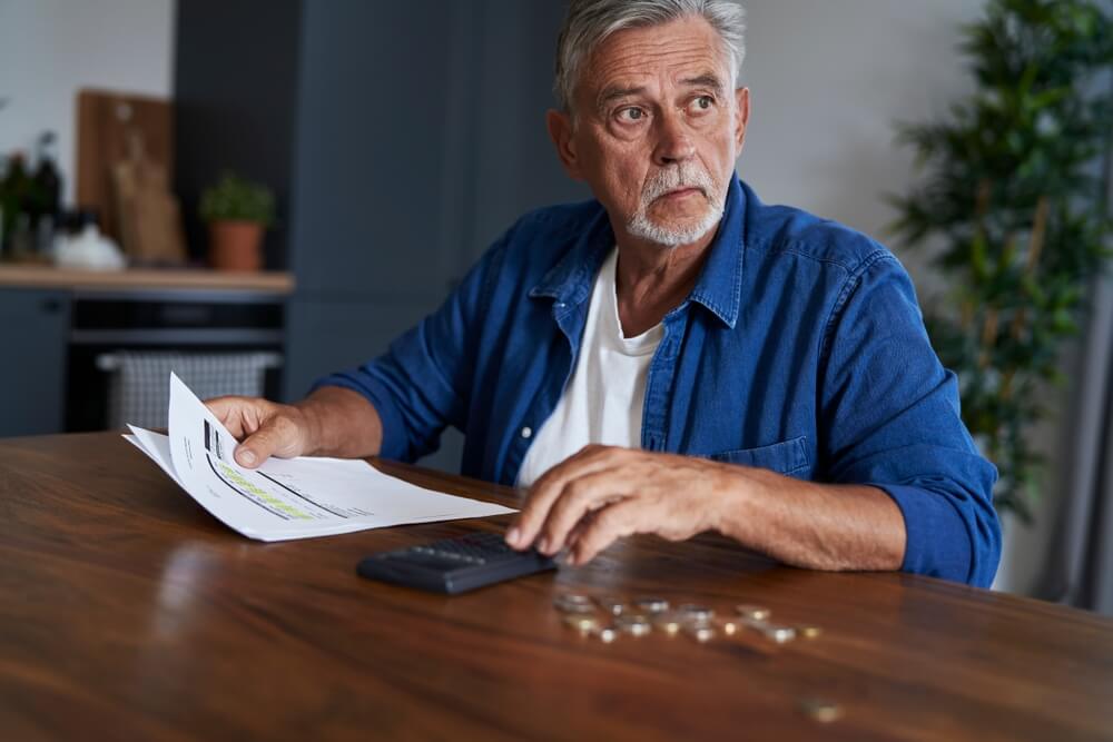 Man calculating his finances wondering how he can stop revolving debt