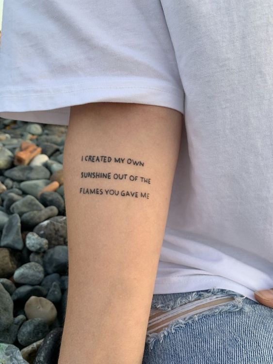quote tattoo on woman's arm