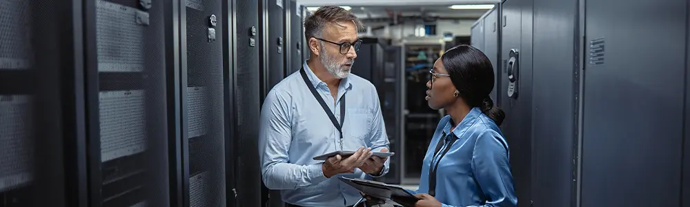 two cmmc professionals talking in a server room