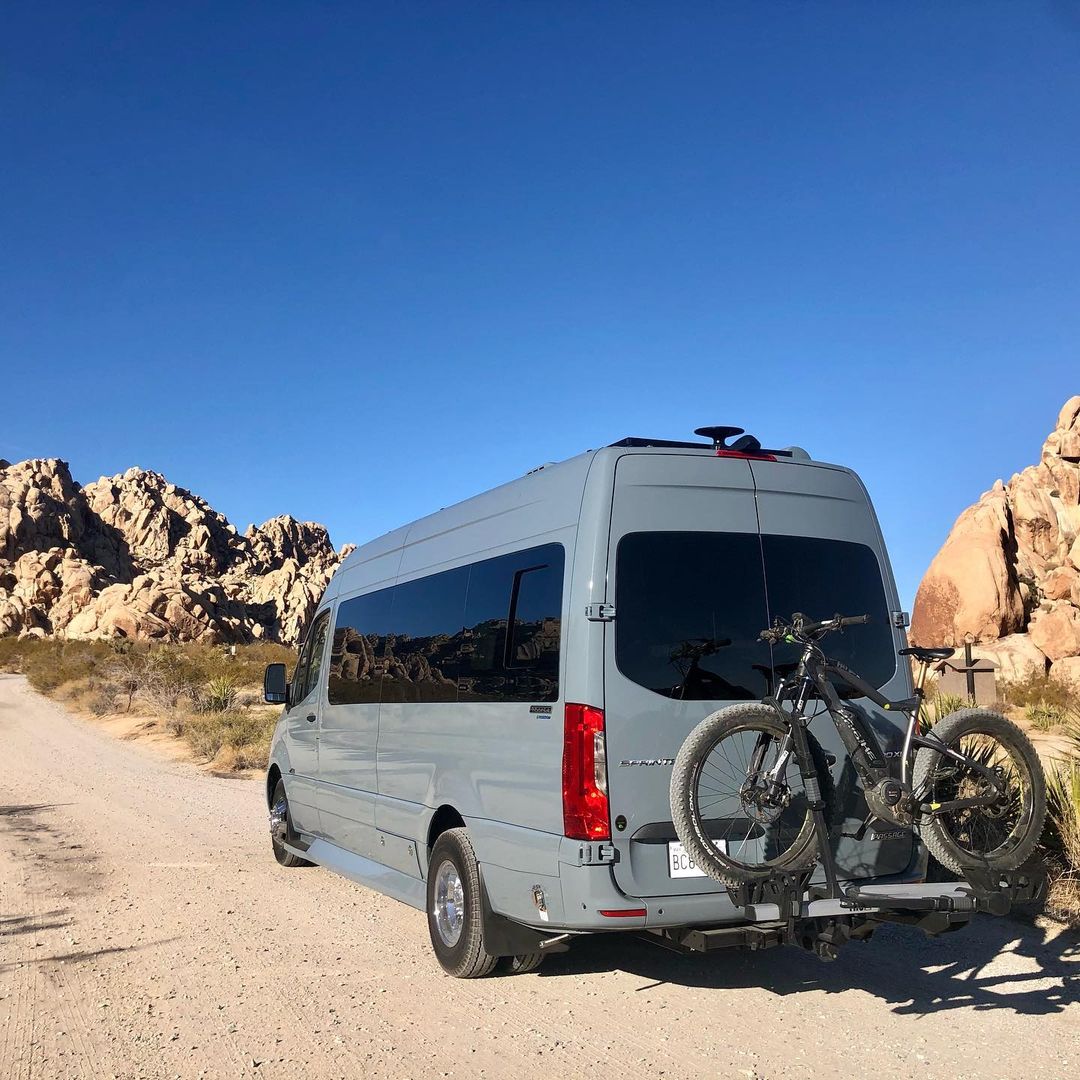 A van with two bicycles on the back of it