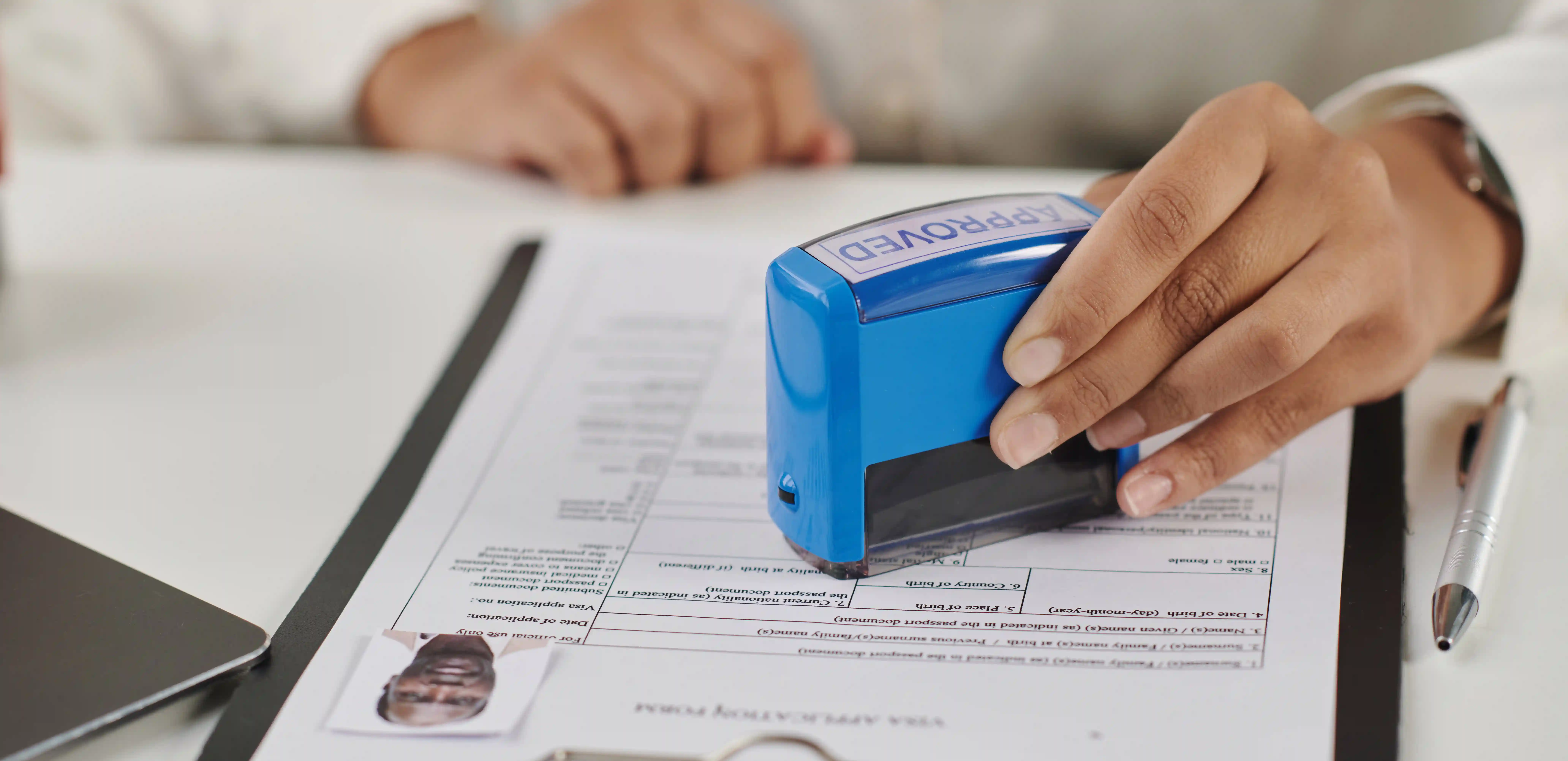 Specialist stamping approved on visa document representing compliant and transparent values-based talent sourcing