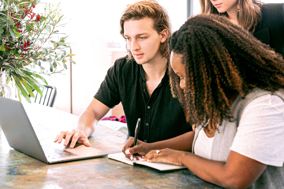 Man and woman working on a laptop creating their marketing plan