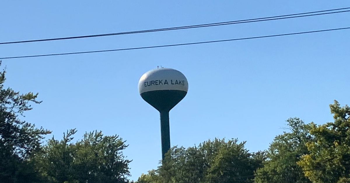 A water tower saying 'Lake Eureka' above trees