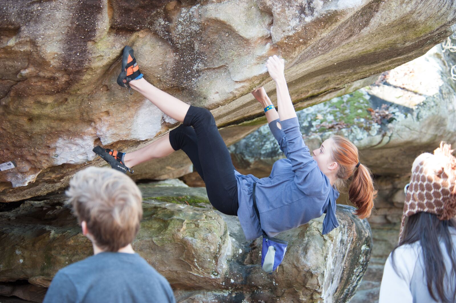 Woman rock climbing with no equipment