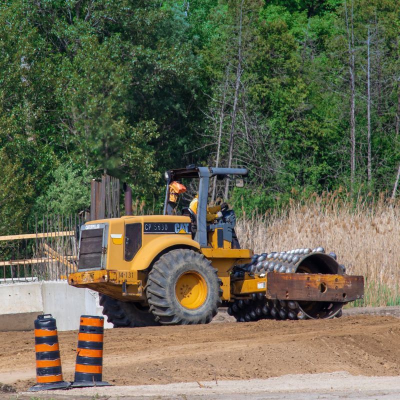 Padfoot roller compacting dirt on a job site