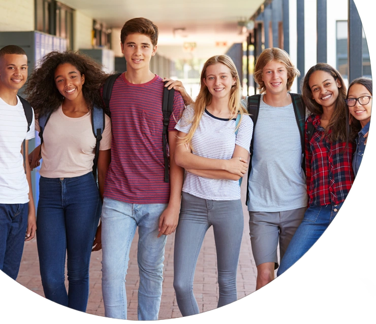 Teenage classmates standing in high school hallway