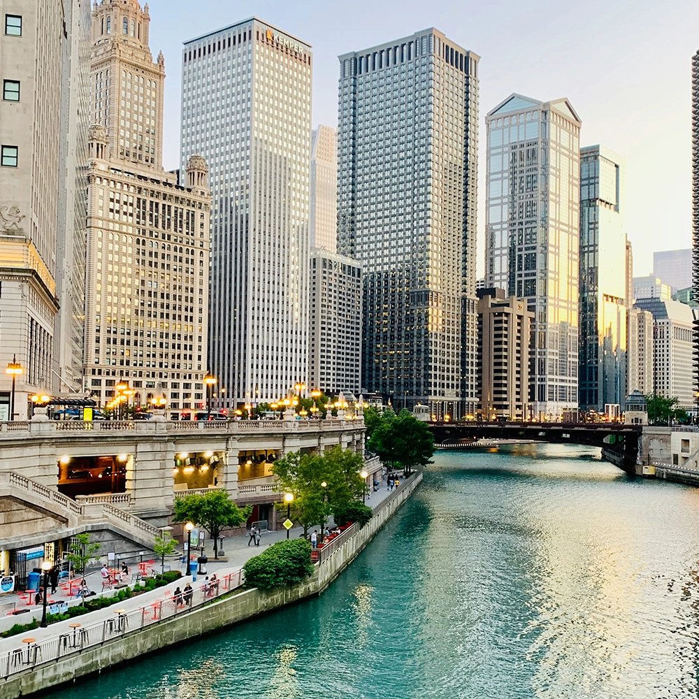 Skyscrapers in a city next to a beautiful riverwalk