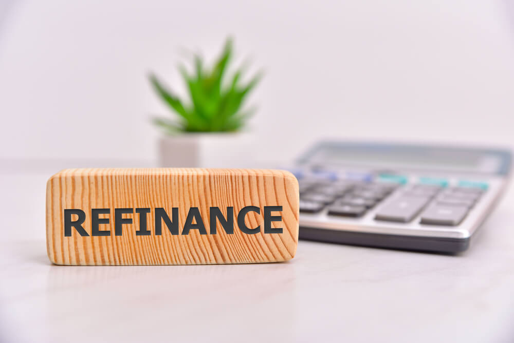 Wooden plaque with the word refinance