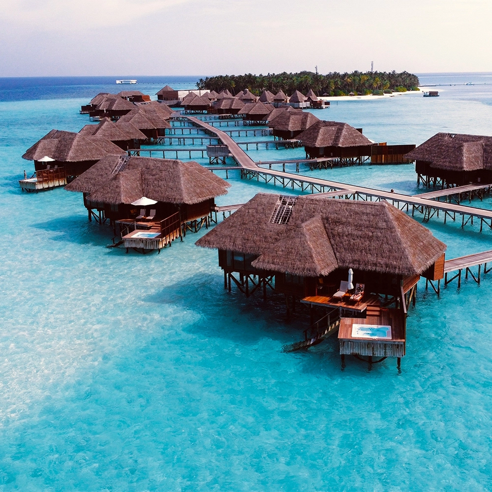 Wooden cottages on the blue waters of the Maldives.