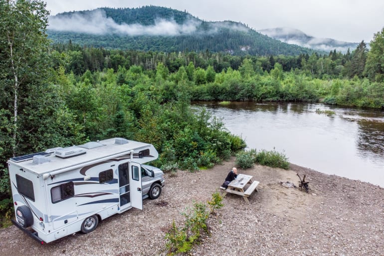 Man Sitting By River with Class C