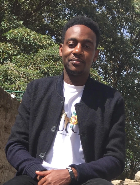 Photograph of Joshua, a Pathways student from Kenya, sitting down