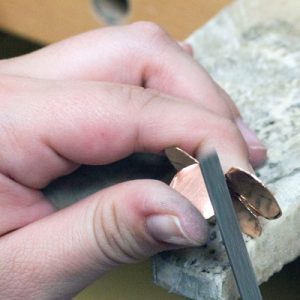 Shaping copper metal with files