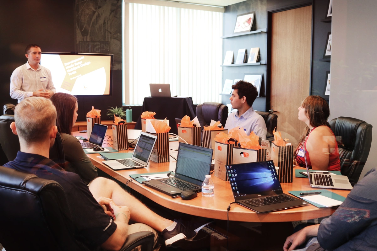 A marketing team discussing the difference between their B2B and B2C marketing campaigns and strategies inside the board room