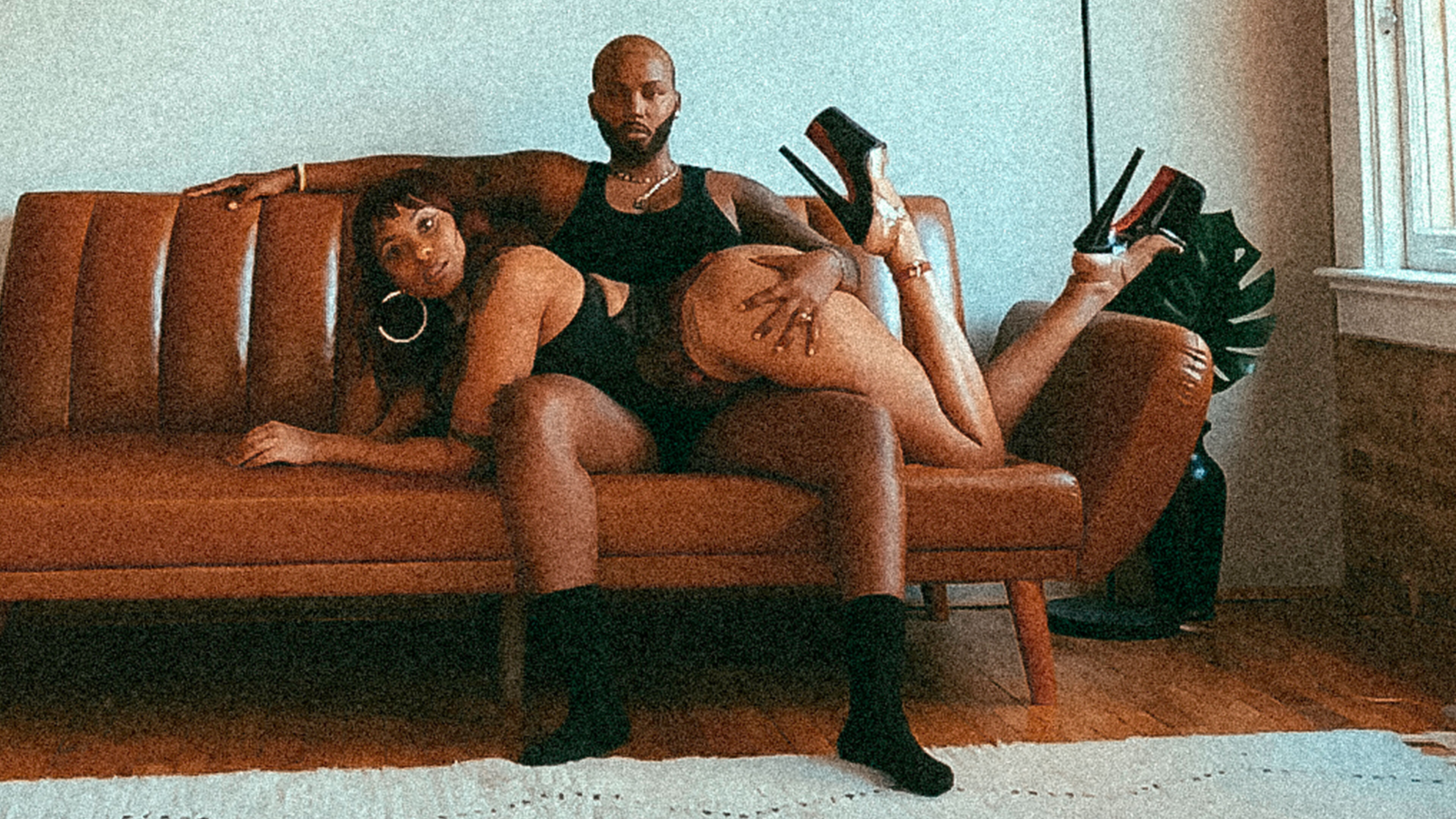 Kaz and Majic sitting on a couch and looking at camera