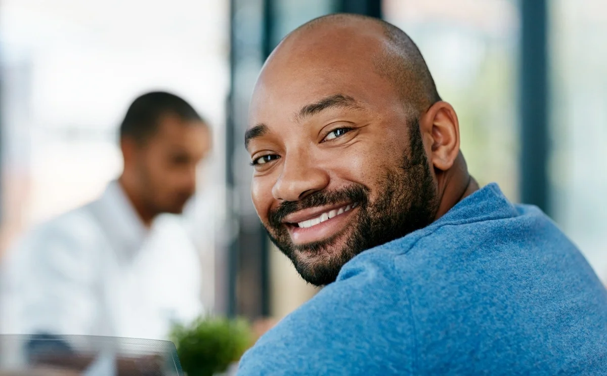 Finance representative smiling at desk