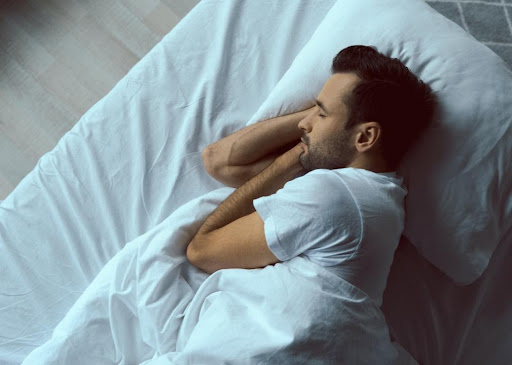 Man Sleeping In White Sheets.jpeg