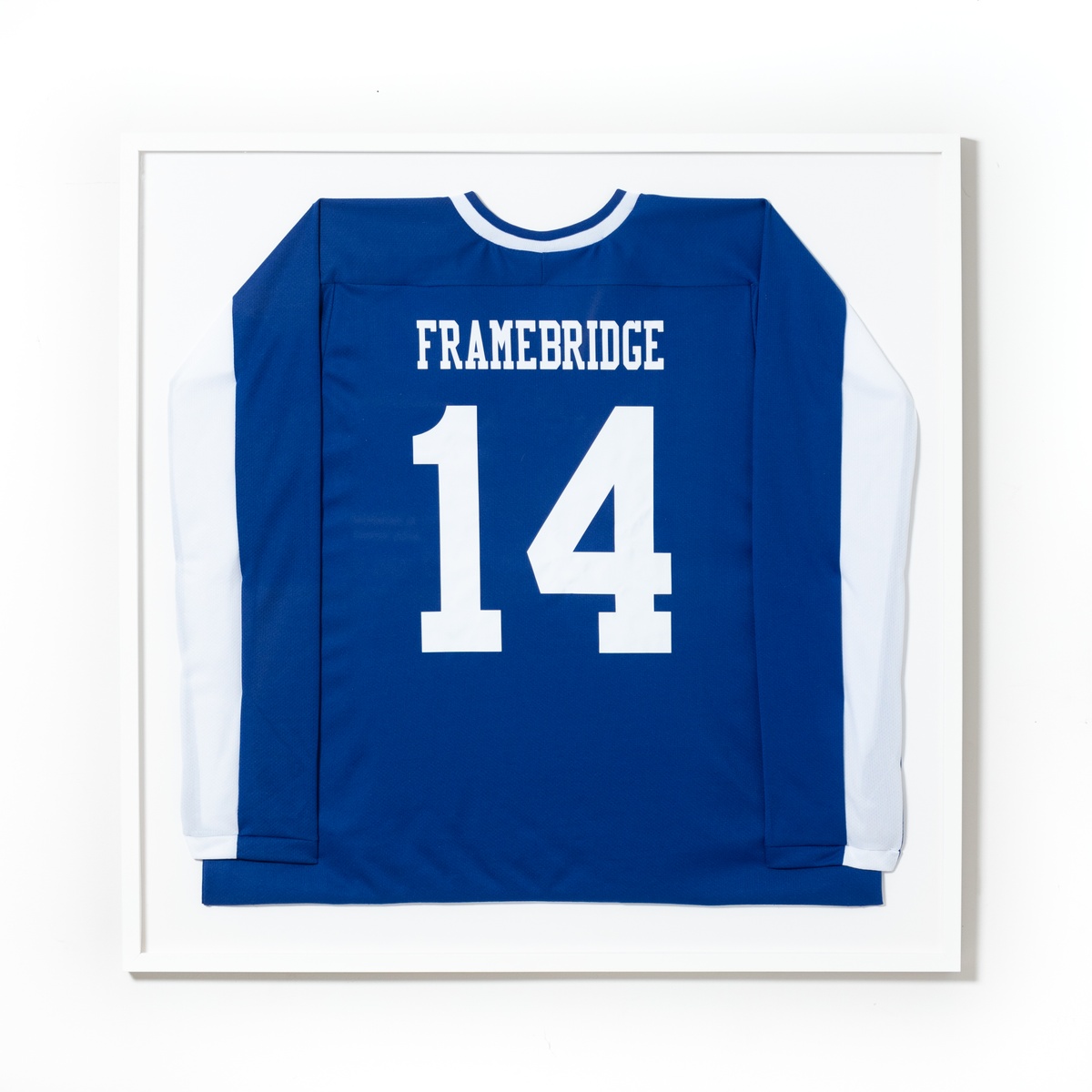blue and white hockey jersey in white frame