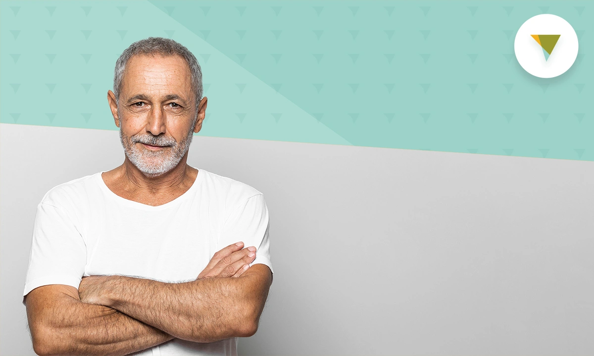 senior man in white shirt looking at camera.
