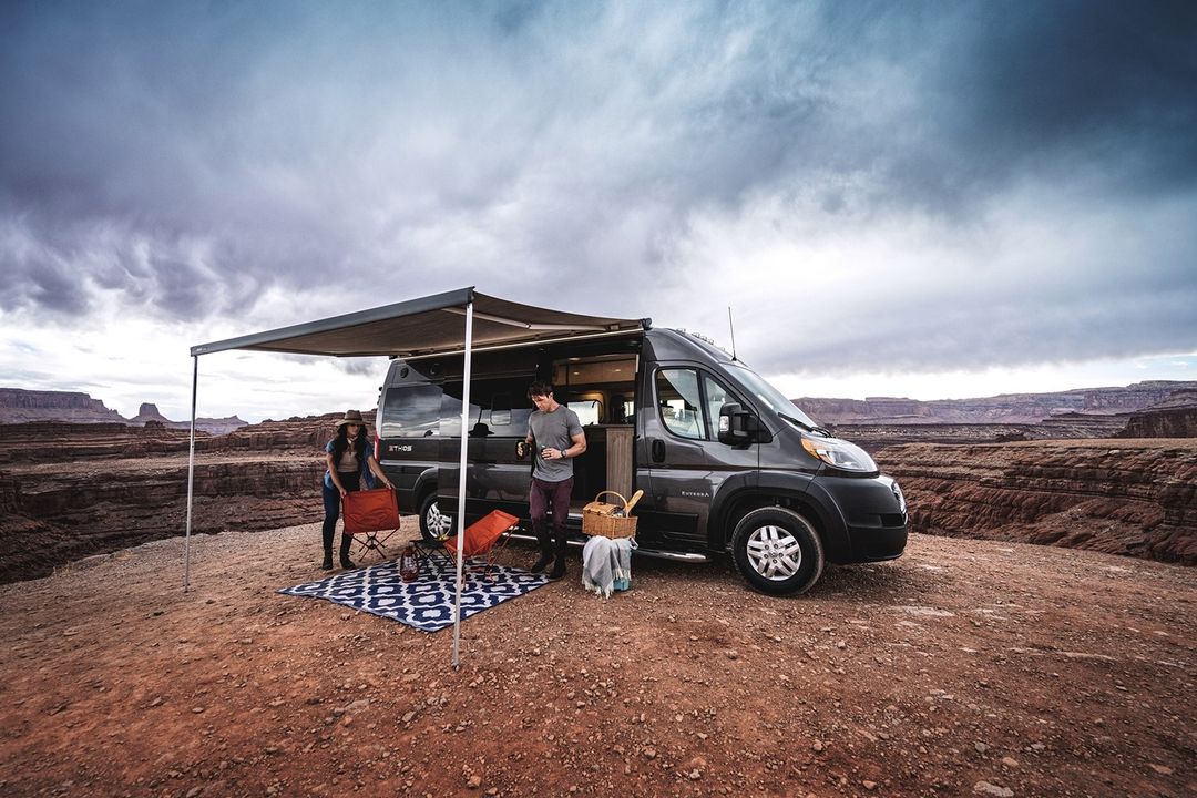 A group of people standing in front of a van