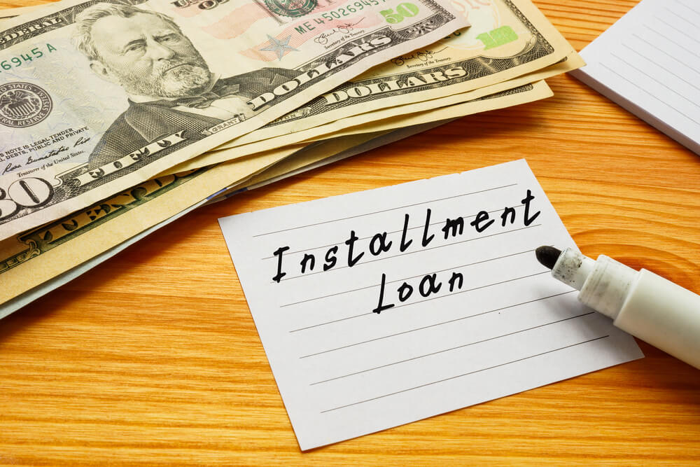 installment loan written with cash on table