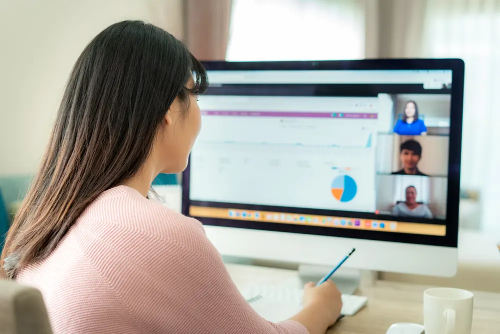 woman participating in online meeting on pc