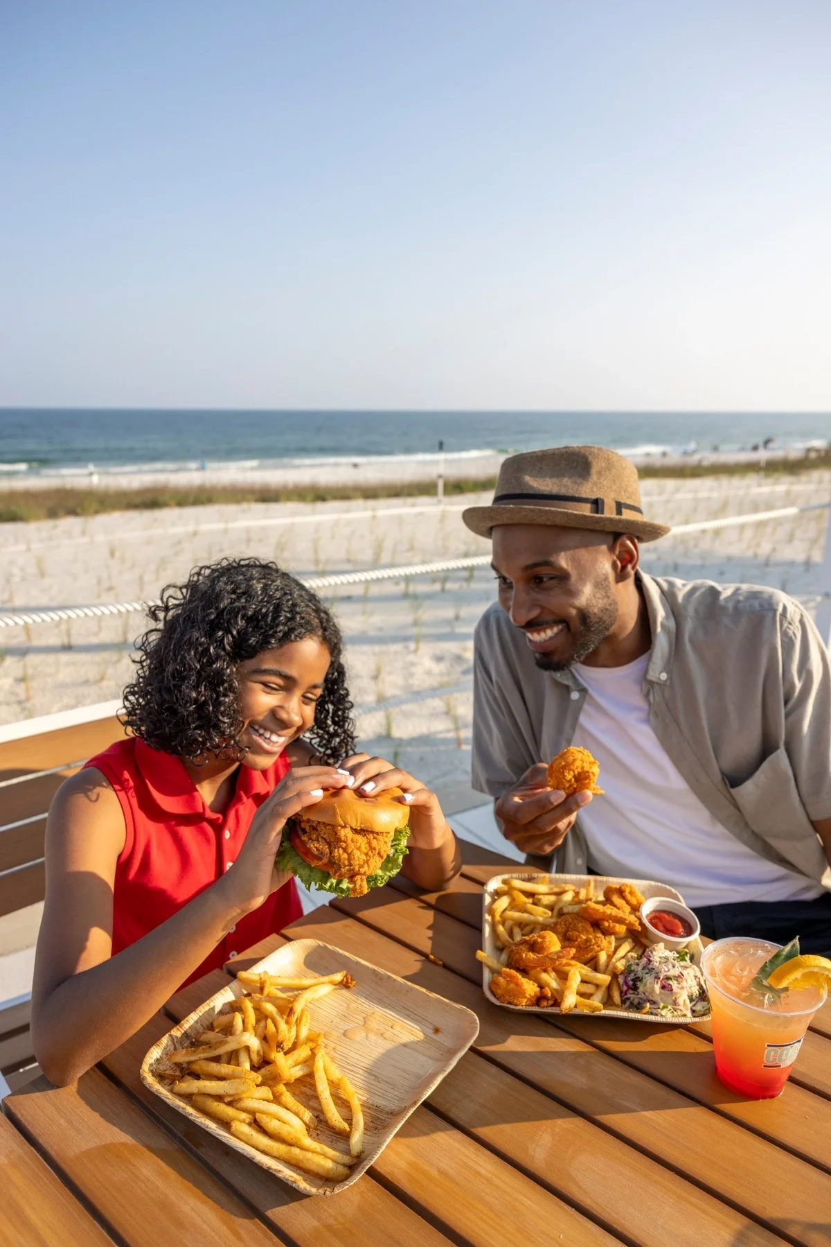 2 people eating at beachside