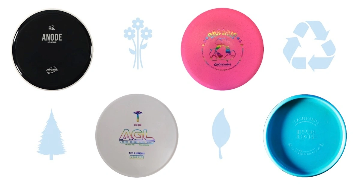 disc golf discs with symbols of nature and the recycling symbol on white background