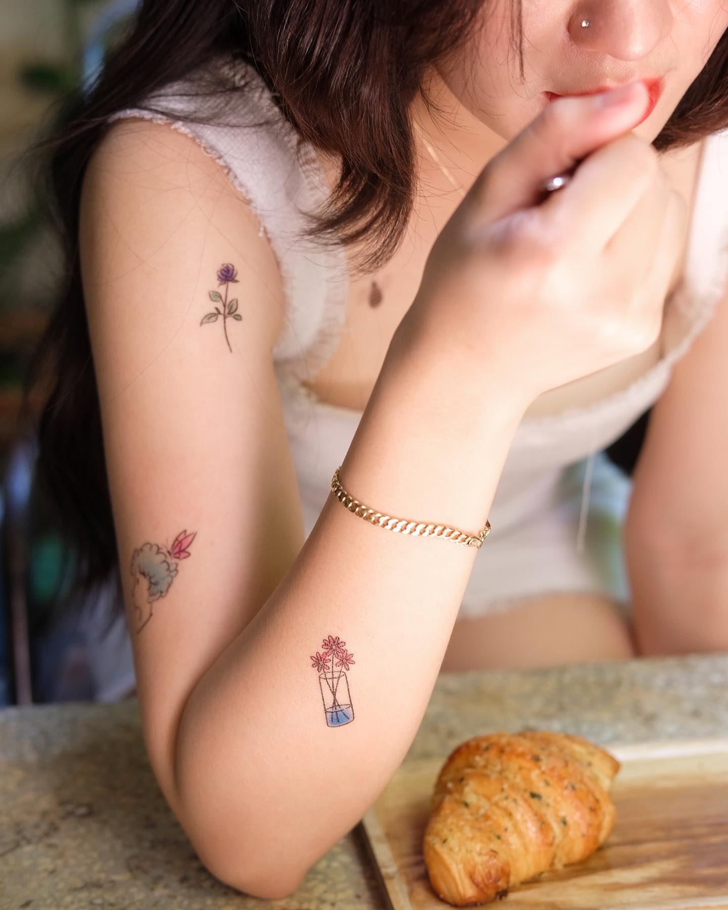 girl with temporary tattoos on arm