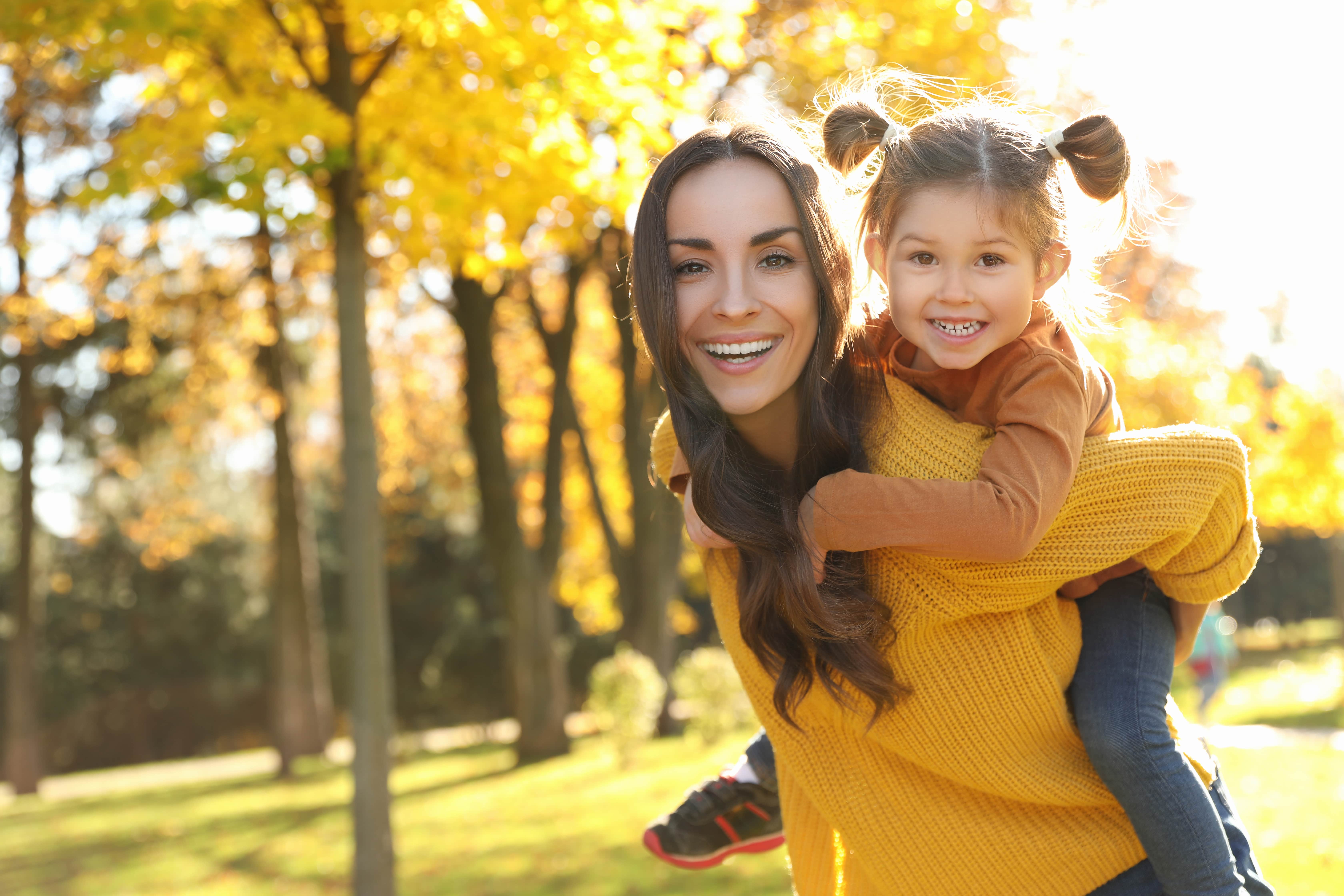 Mother and daughter outside during the fall