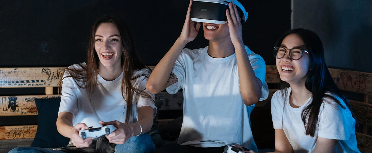 Three friends enjoy playing a virtual reality game.