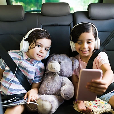 Siblings watching a show on parent phone.