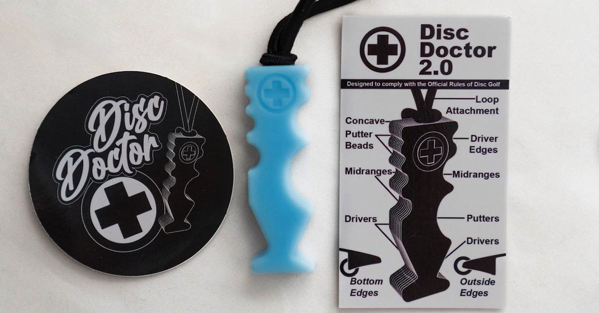 A small blue device next to a Disc Doctor branded plastic circle