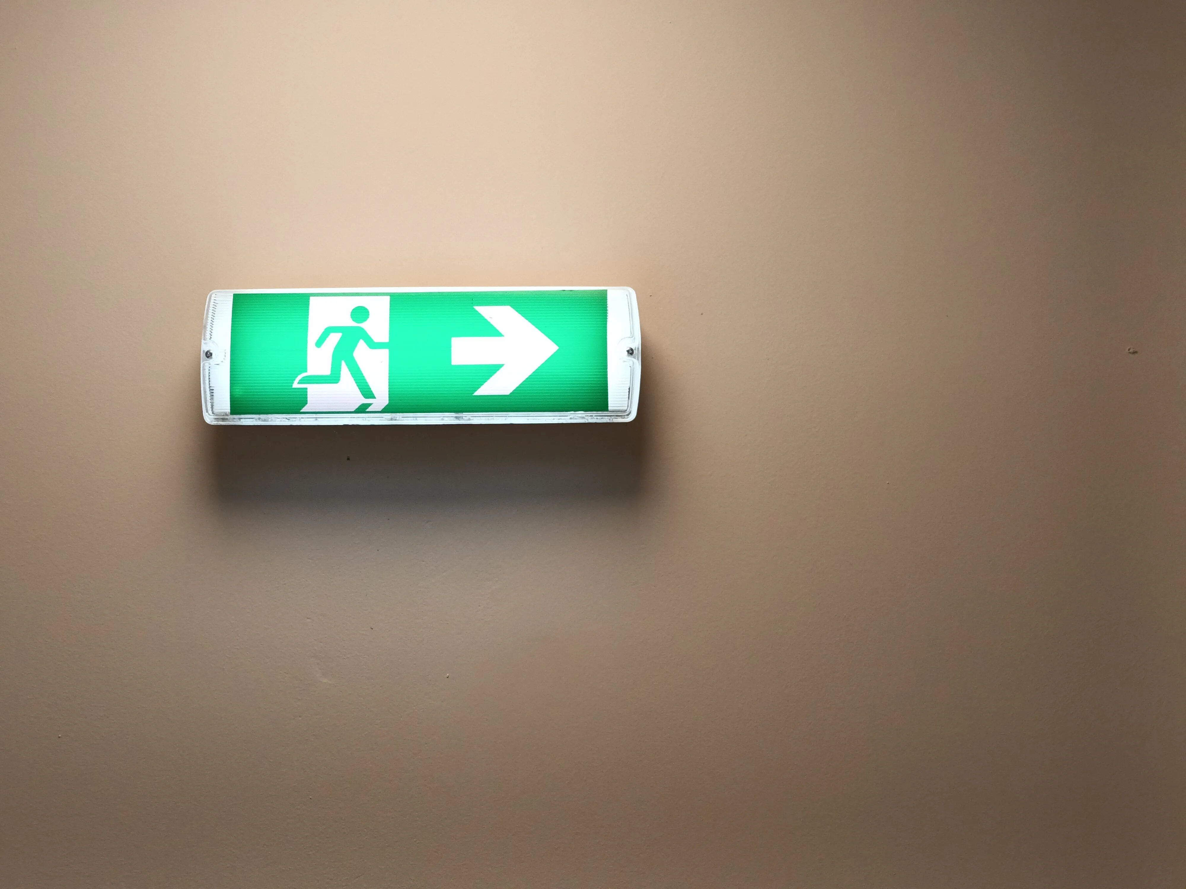 Exit sign symbolizing the shift away from traditional outsourcing toward modern remote staffing models