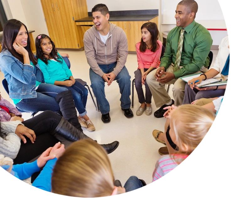 Group of Teachers sitting with students in a circle