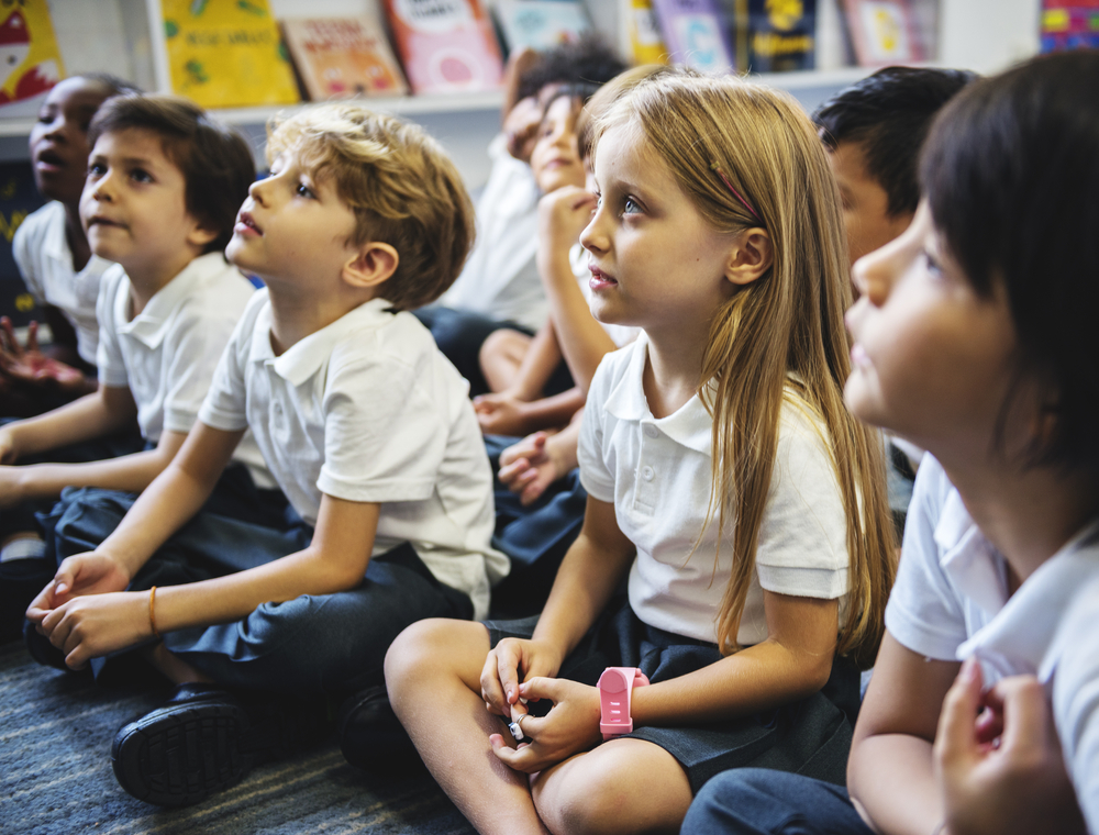 school kids listening to teacher