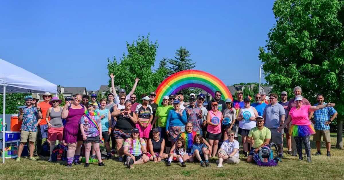 A group of people pose for the camera with discs and smiles