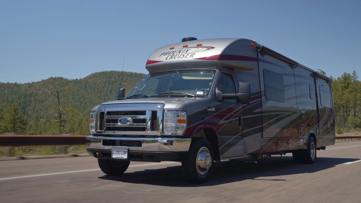 A silver rv on the road