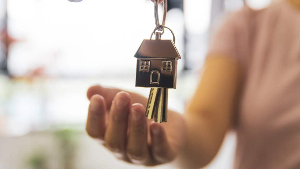 Landlord handing a set of keys to a tenant