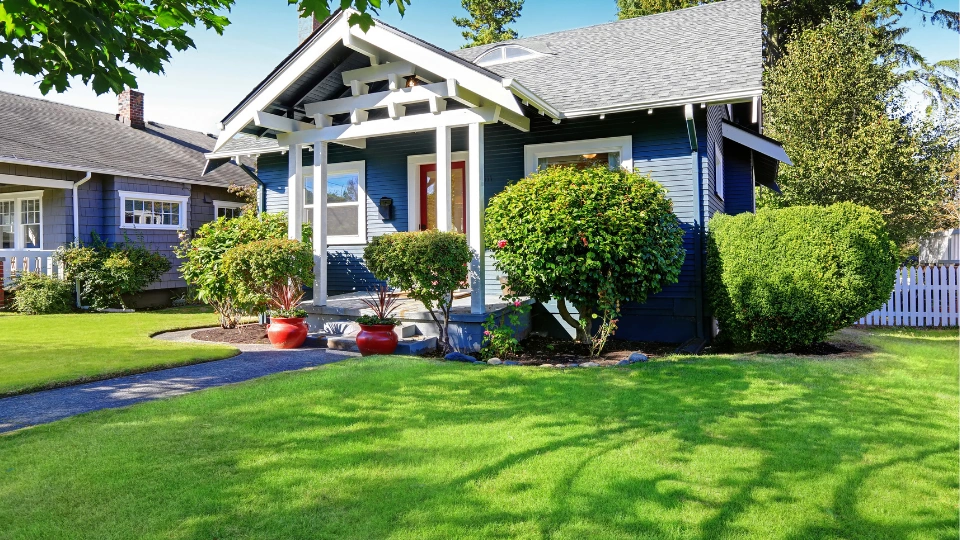 Simple house with blue exterior. Front porch with curb appeal
