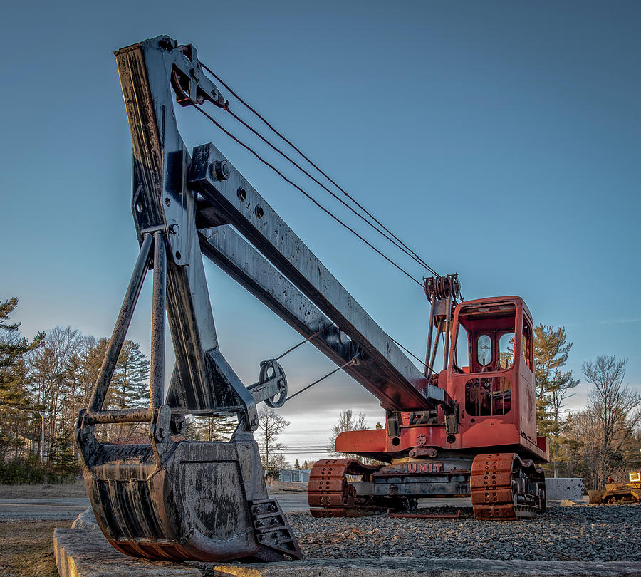 An orange cable excavator on a job site