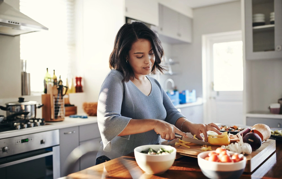 A woman cooking in a kitchen