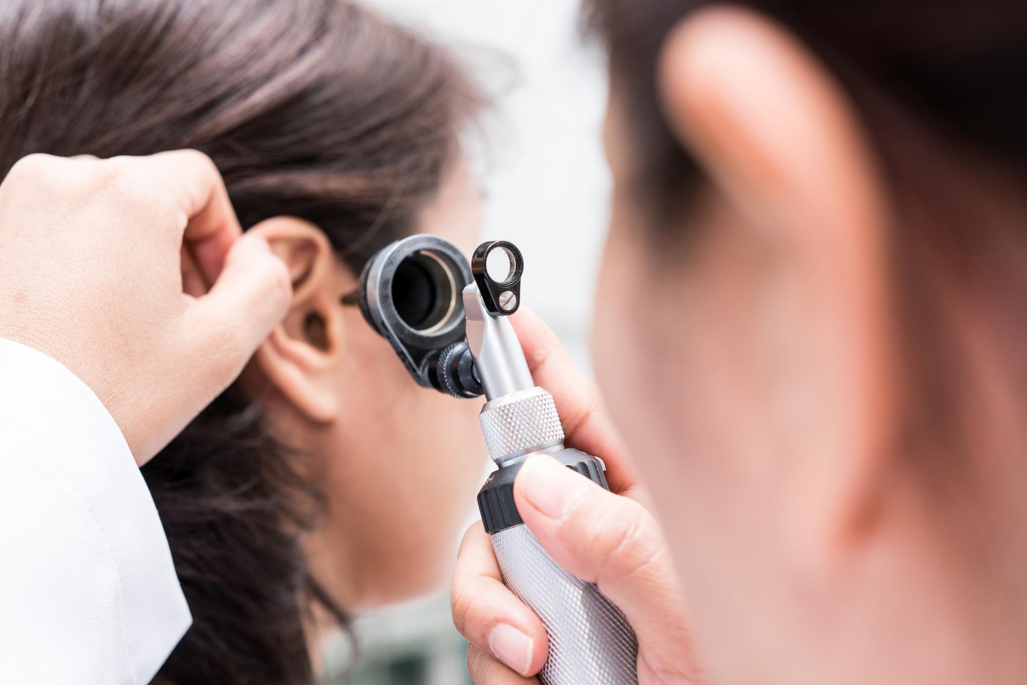 is hearing loss a disability: Doctor examining a patient's ear