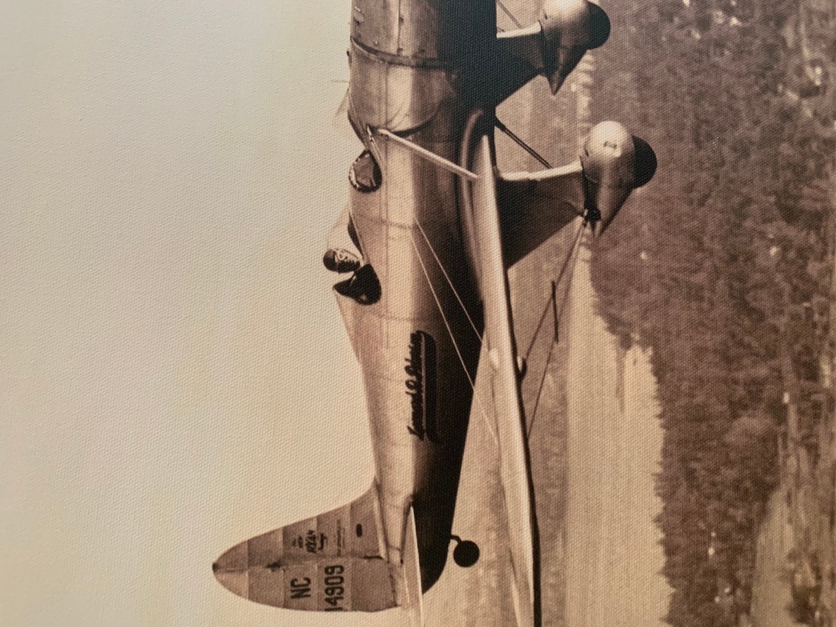 Man flying old timey plane