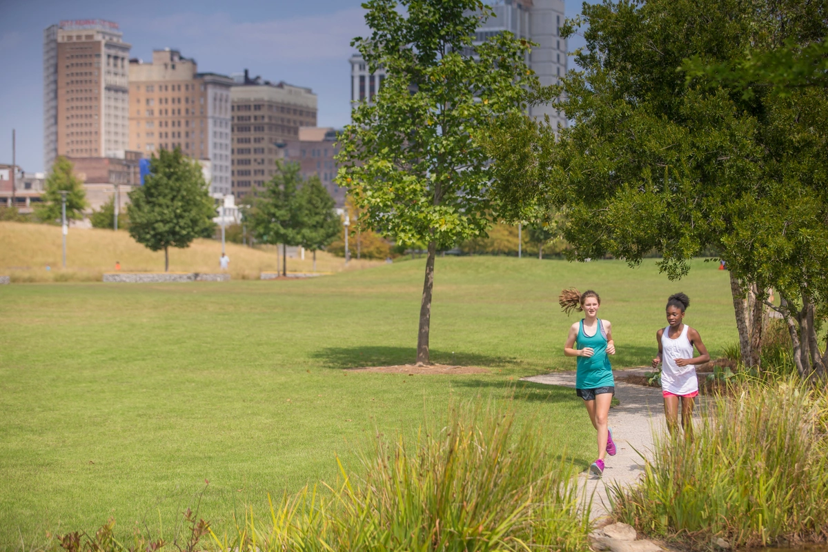 Woman running along a path in a park