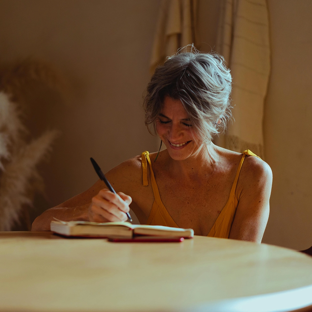 Older woman writing in journal.webp